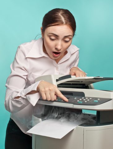 surprised woman with smoking copier